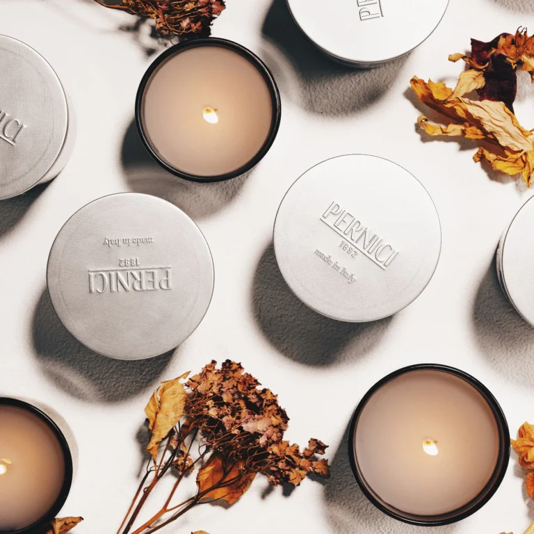 a group of candles and dried flowers